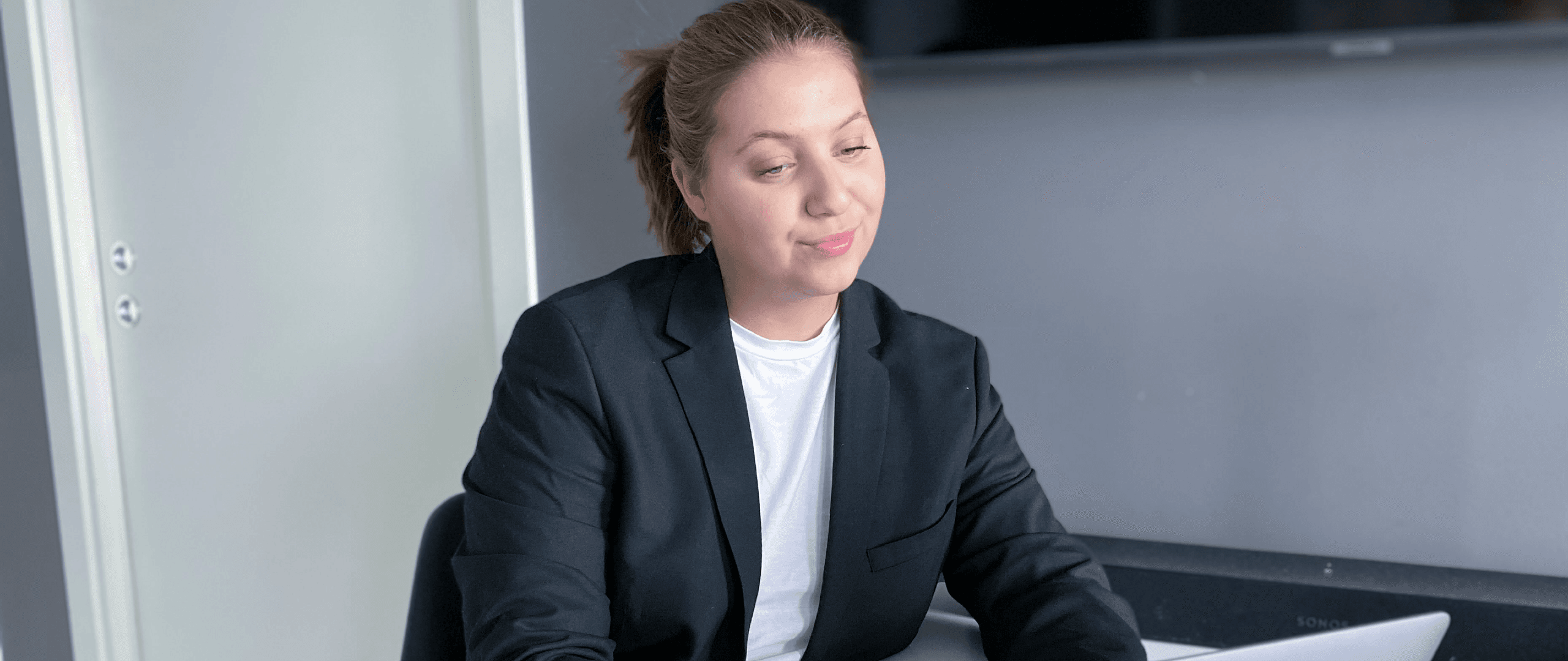 Young lady at desk with laptop investing in cryptocurrency